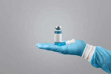 Doctor or scientist holding a syringe with liquid vaccines booster.