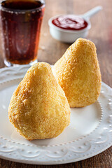 Closeup of Coxinha - Typical Brazilian Snack  on a wooden table