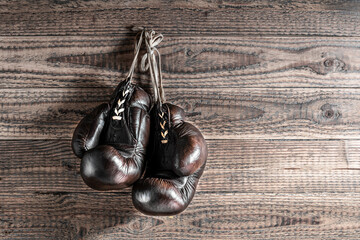 old boxing cloves on wooden wall