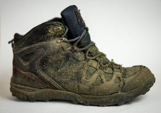 old and used hiking shoe on a white background