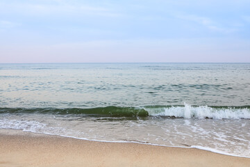 Beautiful sea summer abstract background. Golden sand beach with blue ocean and cloudscape and sunset in the back.