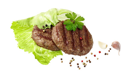 Two grilled cutlet beef minced meat for burger or dinner dish with parsley, garlic and pepper on salad leaf