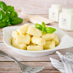 Homemade gnocchi with cheese and basil.