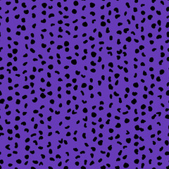 Abstract seamless pattern from small shapes. Simple background of irregular spots. Abstract wild animal skin print. Random spaced black spots. Vector illustration on deep purple background