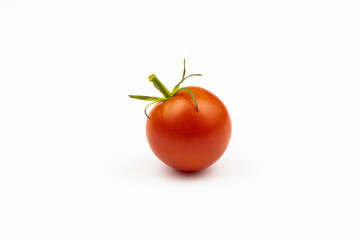 A small ripe tomato isolated on a white background.