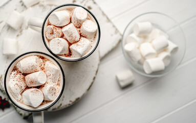 Cocoa mugs filled with white marshmallow