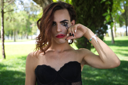 Young Latina And Transsexual Woman Dressed In Fine Black Lingerie. The Woman Is Posing For The Camera With Her Mascara Smudged From Crying Because Of Discrimination. Concept Diversity, Transgender.