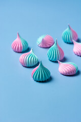 Close-up colorful meringue on blue background