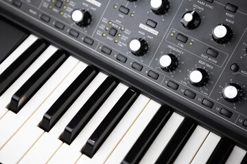 Professional synthesizer piano keyboard and volume regulators. Modern analog synth for electronic music production in sound recording studio 