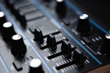 Synthesizer device in sound recording studio. Volume regulators on midi controller device....