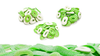 Frame of assorted green gummy candies isolated on white. Top view. Space for text or design.