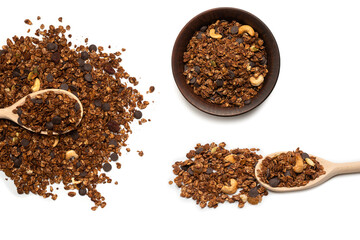 Chocolate granola cereal with nuts in a wooden spoon.