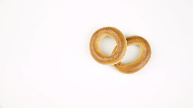 Dried sweet bages on a white background, rotating composition with copy space, footage