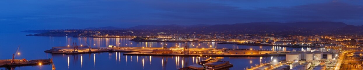 Panoramic view of the port of Musel with the city of Gijón behind