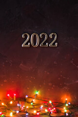 A New Year's card. New Year, Christmas. 2022. Garland on a dark background.
