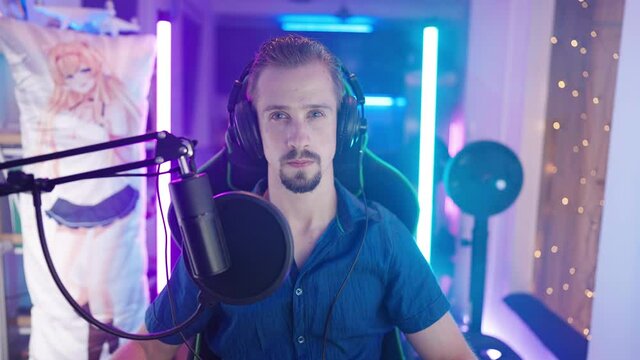 Gamer otaku in neon lights with dakimakura in background looking at camera 4K