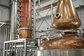 Modern distillery equipment. Industrial equipment for whisky production. The copper vacuum still for distillation performed under reduced pressure for brandy production.