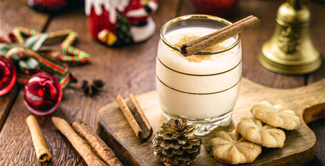 winter drink made with eggs, liqueur, rum and cinnamon, called Christmas eggnog, decorated with...