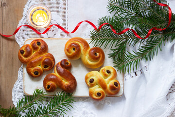 Traditional Swedish saffron buns of various shapes on a light background.