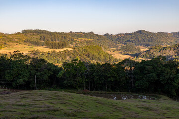 Farm field with lake, forest and valley
