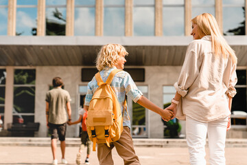 Parents going back to school with their children after summer holidays lockdown. The start of new academic semester year. Preparation for lessons classes