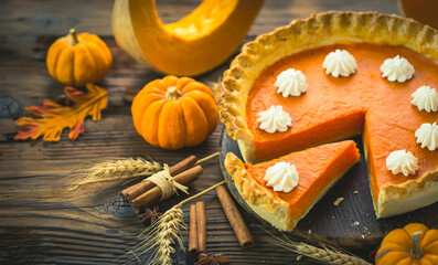 Fresh homemade pumpkin pie on the wooden table
