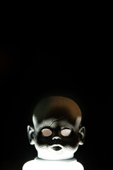 Creepy head of a hunted doll