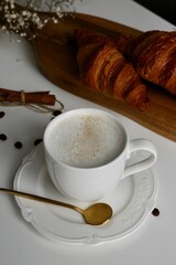 cup of coffee with croissant