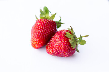 Two appetizing brightly red strawberries on a white background