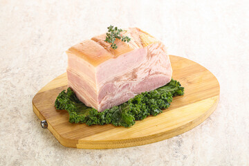 Cut of pork bacon over board