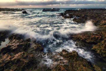 Waves crashing against the rocks as a hurricane approaches.