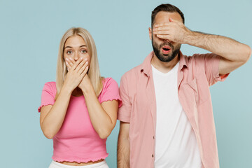 Young couple two friends family man woman in casual clothes looking camera cover mouth eyes with hand together isolated on pastel plain light blue background studio portrait People lifestyle concept.