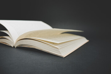 Open book on black background.