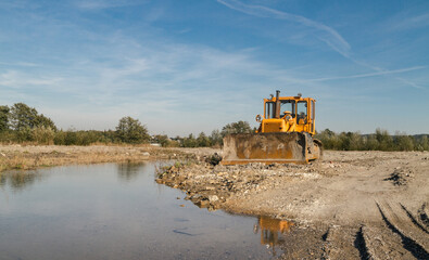 Large yellow bulldozer (dozer or crawler) on a construction site.