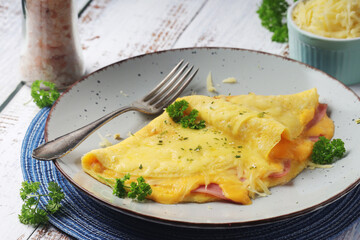 Omelette with ham and cheese on the plate