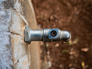 close-up of garden faucet with broken knob
