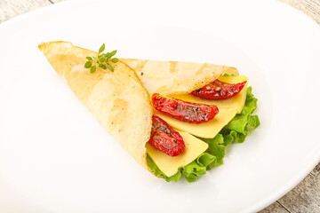 Pancake with cheese and dry tomato
