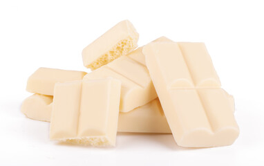 Lots slices of white chocolate isolated on white background close up
