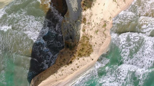 Sea waves roll onto shore, top-down view. Camera slowly goes down. Logas Beach on Corfu Island, Greece.