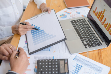Fototapeta na wymiar Business adviser analyzing financial figures denoting the progress Internal Revenue Service checking document. Audit concept