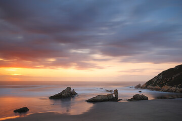 Fototapeta na wymiar Photography of a long exposure in a sunset in the Playón de Bayas, Asturias, Spain