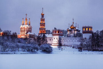 View of the architectural ensemble of the Novodevichy convent on a winter evening. Moscow, Russia