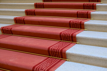Red carpet on white marble stairs