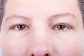 the eye is open. studio lighting. the girl is aged from 30 to 45 years. aging of the skin and eyes. macro. close-up.