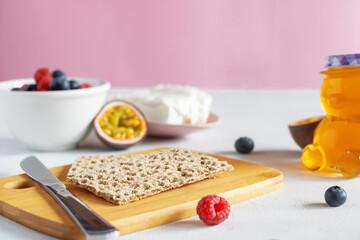 A table full of healthy breakfast products. A healthy breakfast: crisp bread, raspberries,...