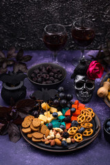 Halloween appetizers. Cheese plate with snacks