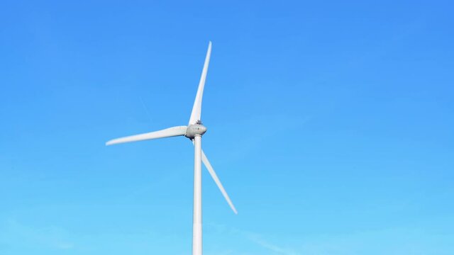 Wind turbine against blue sky, Niagara Region Wind Farm 230 MW of electricity