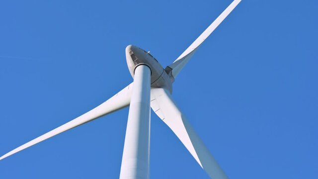 Wind turbine against blue sky, Niagara Region Wind Farm 230 MW of electricity
