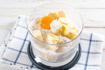 Pastry preparation, butter, eggs and flour in a food processor.