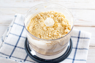 Stage of preparing shortcrust pastry in food processor in process of cooking.